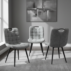 Three gray chairs in a room with abstract art on the wall.