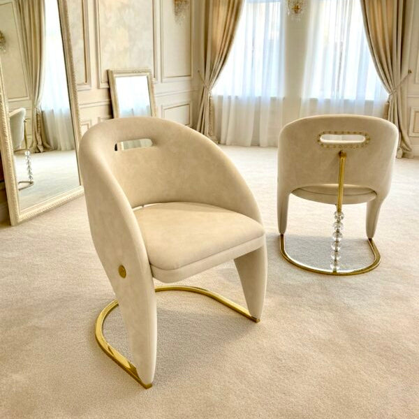 Luxurious interior with beige chairs, large mirror, and elegant decor.